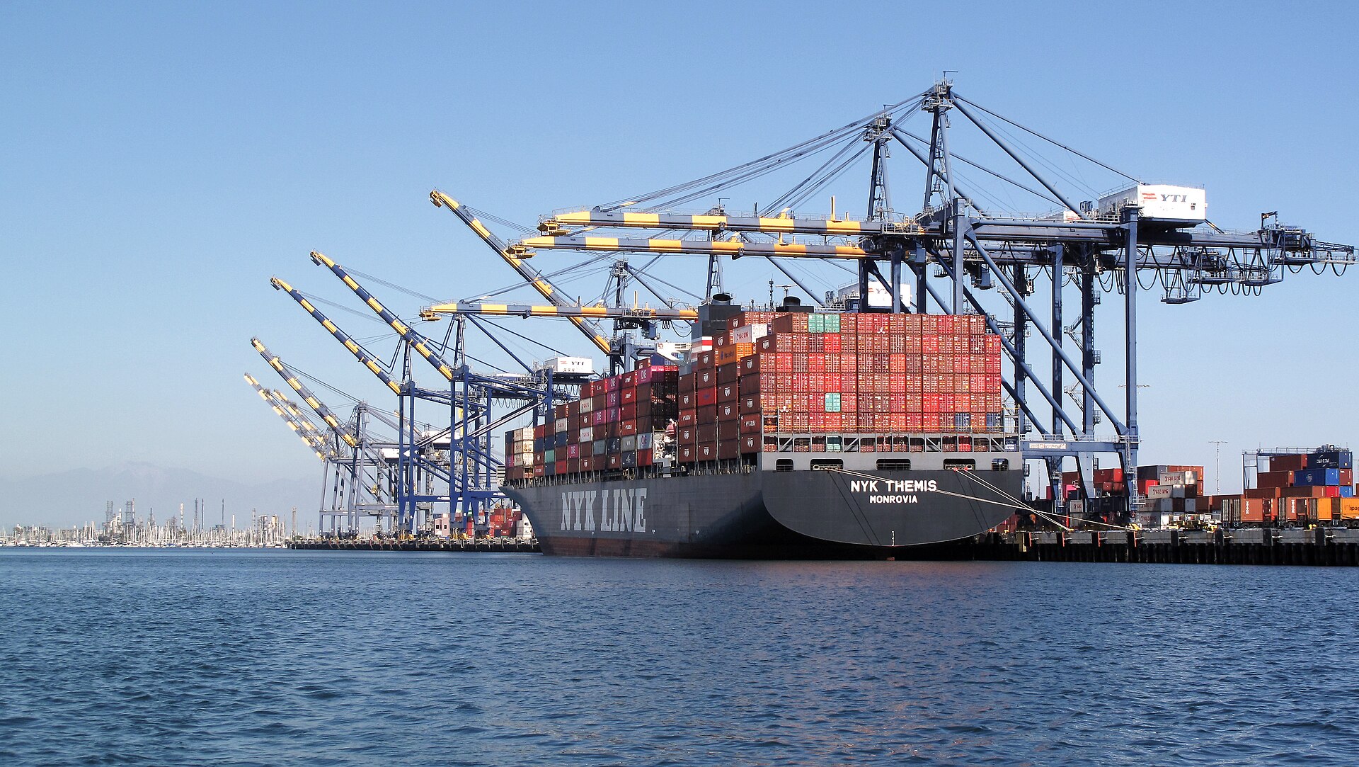 A container ship alongside the quay under cranes